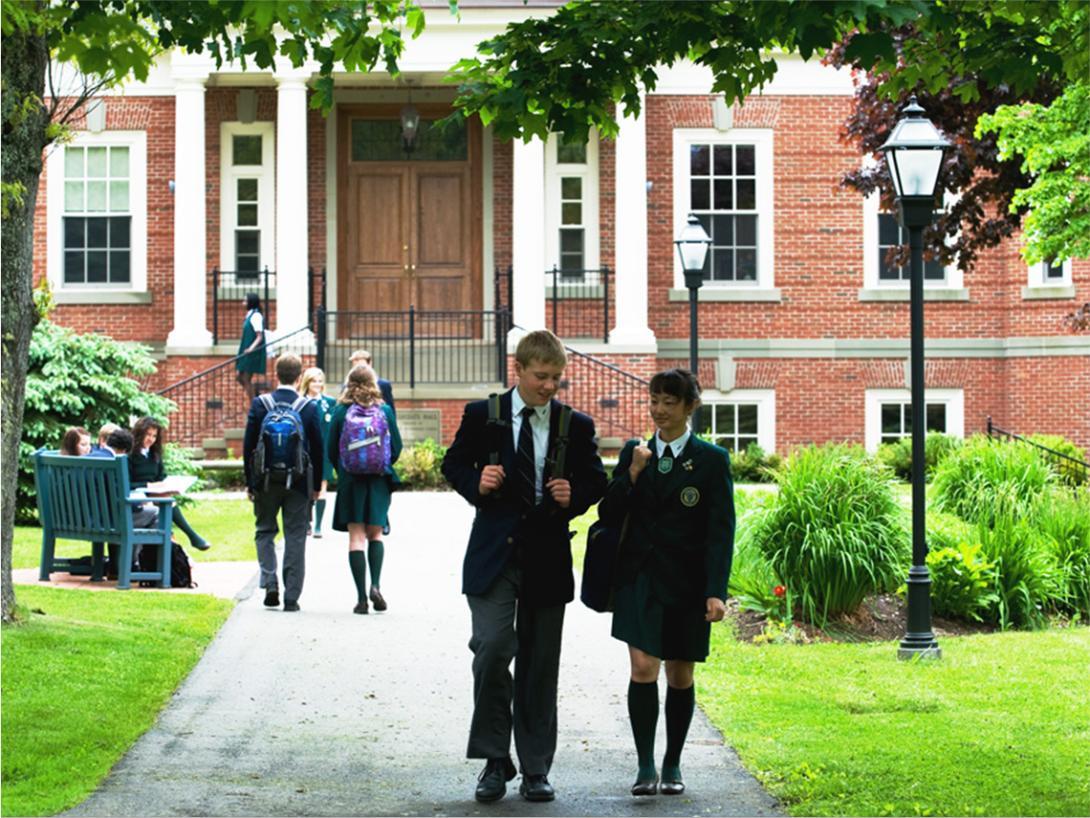 Students infront of a private school wearing school uniforms