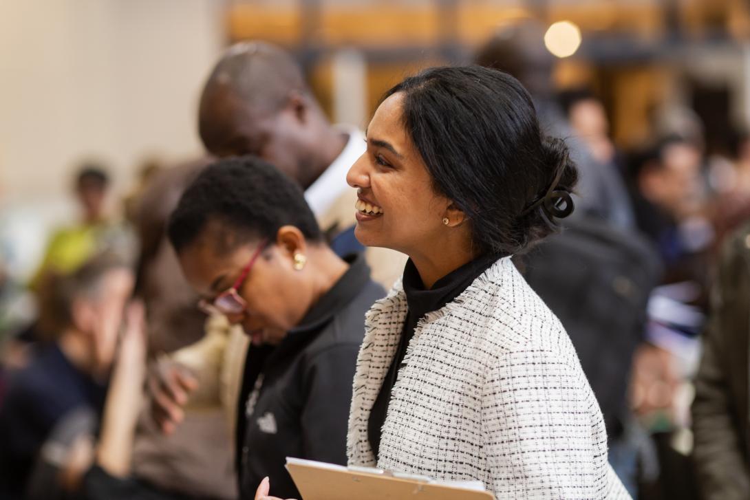 Person at a job fair holding their resume