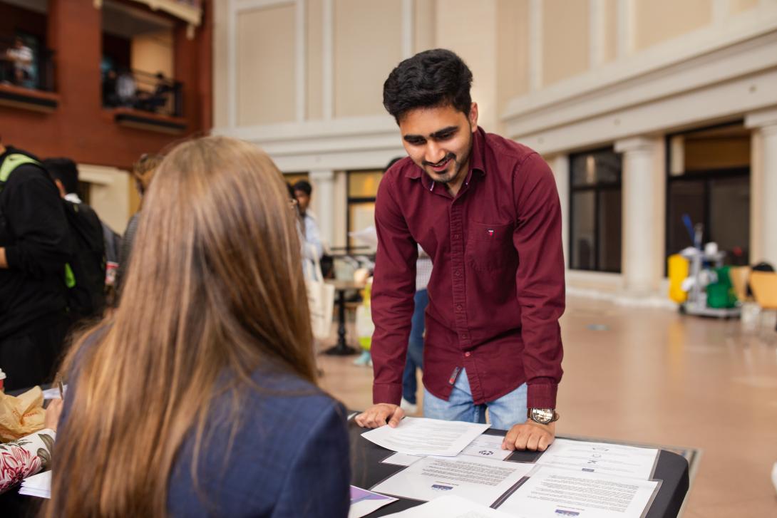 Two people talking at a job fair