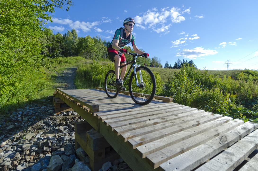 Someone biking across a bridge