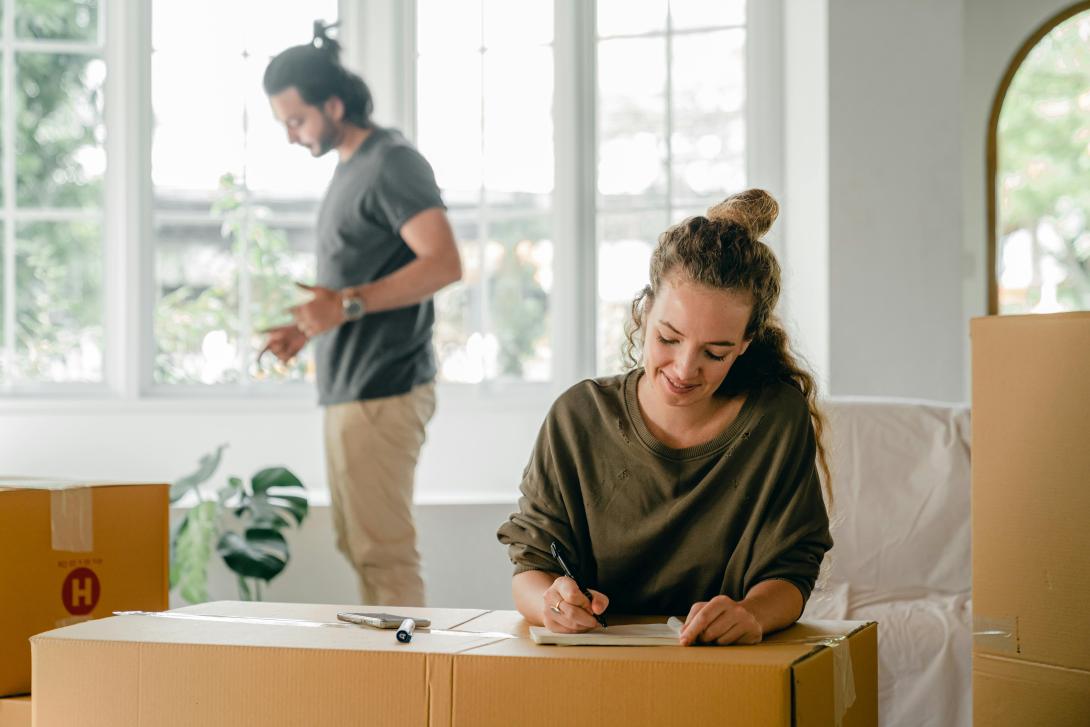 Two people moving into a new home