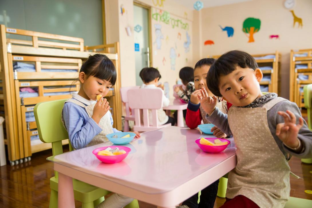 Children sitting at table during daycare